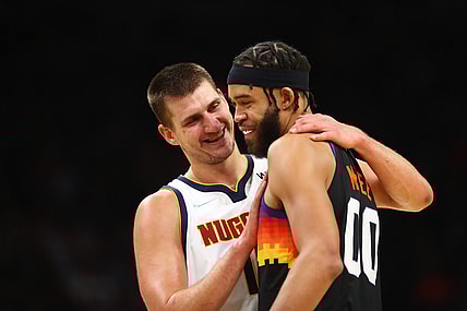 Oct 20, 2021; Phoenix, Arizona, USA; Denver Nuggets center Nikola Jokic (left) greets Phoenix Suns center JaVale McGee in the first half at Footprint Center. Mandatory Credit: Mark J. Rebilas-USA TODAY Sports
