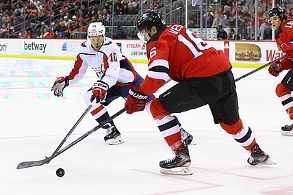 Oct 21, 2021; Newark, New Jersey, USA; New Jersey Devils left wing Jimmy Vesey (16) plays the puck while being defended by Washington Capitals right wing Daniel Sprong (10) during the first period at Prudential Center. Mandatory Credit: Ed Mulholland-USA TODAY Sports