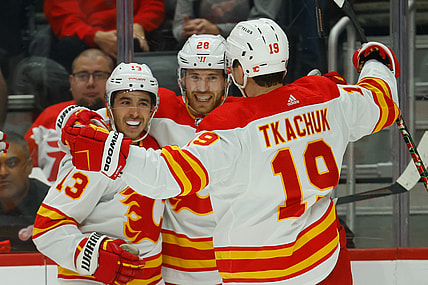 Oct 21, 2021; Detroit, Michigan, USA; Calgary Flames center Elias Lindholm (28) receives congratulations from teammates after scoring in the first period against the Detroit Red Wings at Little Caesars Arena. Mandatory Credit: Rick Osentoski-USA TODAY Sports