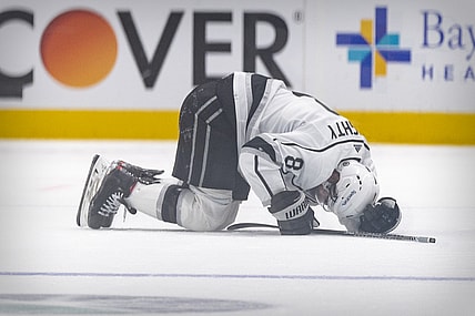 Oct 22, 2021; Dallas, Texas, USA; Los Angeles Kings defenseman Drew Doughty (8) lies on the ice after getting injured on a hit by Dallas Stars defenseman Jani Hakanpaa (not pictured) during the second period at the American Airlines Center. Mandatory Credit: Jerome Miron-USA TODAY Sports
