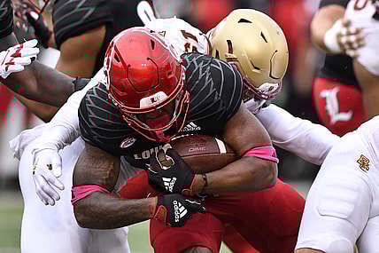 Oct 23, 2021; Louisville, Kentucky, USA;  Louisville Cardinals running back Jalen Mitchell (15) pushes past Boston College Eagles linebacker Isaiah Graham-Mobley (19) to score a touchdown during the second quarter of play at Cardinal Stadium. Mandatory Credit: Jamie Rhodes-USA TODAY Sports
