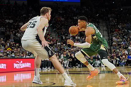 Oct 23, 2021; San Antonio, Texas, USA;  Milwaukee Bucks forward Giannis Antetokounmpo (34) dribbles against San Antonio Spurs center Jakob Poeltl (25) in the first half at the AT&T Center. Mandatory Credit: Daniel Dunn-USA TODAY Sports