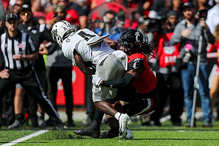 Oct 16, 2021; Cincinnati, Ohio, USA; Cincinnati Bearcats cornerback Arquon Bush (9) brings down UCF Knights wide receiver Ryan O'Keefe (4) in the first half at Nippert Stadium. Mandatory Credit: Katie Stratman-USA TODAY Sports