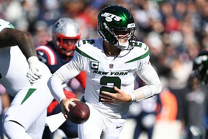 Oct 24, 2021; Foxborough, Massachusetts, USA; New York Jets quarterback Zach Wilson (2) looks to hand off the ball during the first half of a game against the New England Patriots at Gillette Stadium. Mandatory Credit: Brian Fluharty-USA TODAY Sports