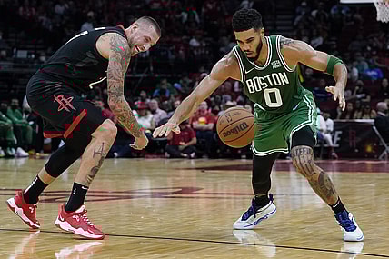 Oct 24, 2021; Houston, Texas, USA; Houston Rockets center Daniel Theis (27) and Boston Celtics forward Jayson Tatum (0) reach for a loose ball in the second quarter at Toyota Center. Mandatory Credit: Thomas Shea-USA TODAY Sports