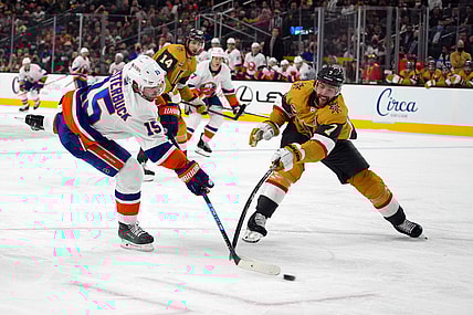 Oct 24, 2021; Las Vegas, Nevada, USA; New York Islanders right wing Cal Clutterbuck (15) and Vegas Golden Knights defenseman Alex Pietrangelo (7) reach for the puck in the first period at T-Mobile Arena. Mandatory Credit: Kirby Lee-USA TODAY Sports