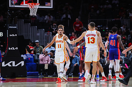 Oct 25, 2021; Atlanta, Georgia, USA;  Atlanta Hawks guard Trae Young (11) high fives guard Bogdan Bogdanovic (13) during the first quarter against the Detroit Pistons at State Farm Arena. Mandatory Credit: Jacob Gonzalez-USA TODAY Sports