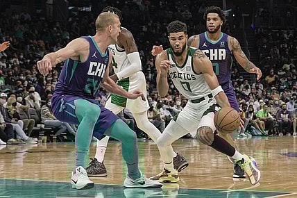 Oct 25, 2021; Charlotte, North Carolina, USA; Boston Celtics forward Jayson Tatum (0) drives to the basket against Charlotte Hornets center Mason Plumlee (24) during overtime at the Spectrum Center. Mandatory Credit: Jim Dedmon-USA TODAY Sports