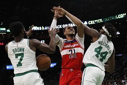 Oct 27, 2021; Boston, Massachusetts, USA; Boston Celtics center Robert Williams III (44) and guard Jaylen Brown (7) knock the ball away from Washington Wizards center Daniel Gafford (21) during the first quarter at TD Garden. Mandatory Credit: Winslow Townson-USA TODAY Sports