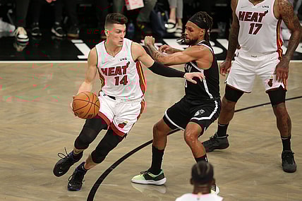 Oct 27, 2021; Brooklyn, New York, USA; Miami Heat guard Tyler Herro (14) controls the ball against Brooklyn Nets guard Patty Mills (8) during the first quarter at Barclays Center. Mandatory Credit: Brad Penner-USA TODAY Sports