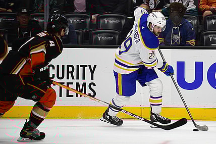 Oct 28, 2021; Anaheim, California, USA; Buffalo Sabres left wing Vinnie Hinostroza (29) moves the puck ahead of Anaheim Ducks defenseman Cam Fowler (4) during the first period at Honda Center. Mandatory Credit: Gary A. Vasquez-USA TODAY Sports