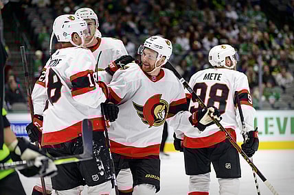 Oct 29, 2021; Dallas, Texas, USA; Ottawa Senators left wing Tim St tzle (18) and right wing Connor Brown (28) and defenseman Victor Mete (98) celebrates a goal scored by Brown against the Dallas Stars during the third period at the American Airlines Center. Mandatory Credit: Jerome Miron-USA TODAY Sports