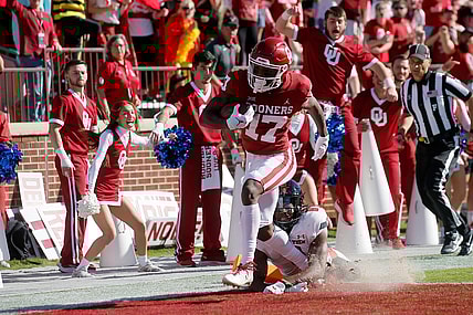 Oklahoma's Marvin Mims (17) scores a touchdown in front of Texas Tech's Malik Dunlap (8) during a college football game between the University of Oklahoma Sooners (OU) and the Texas Tech Red Raiders at Gaylord Family-Oklahoma Memorial Stadium in Norman, Okla., Saturday, Oct. 30, 2021.

Ou Vc Texas Tech