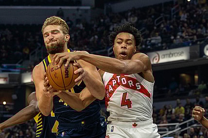 Oct 30, 2021; Indianapolis, Indiana, USA; Indiana Pacers forward Domantas Sabonis (11) and Toronto Raptors forward Scottie Barnes (4) fight for a rebound in the first half at Gainbridge Fieldhouse. Mandatory Credit: Trevor Ruszkowski-USA TODAY Sports