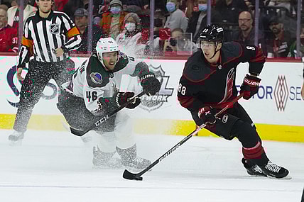 Oct 31, 2021; Raleigh, North Carolina, USA;  Carolina Hurricanes center Martin Necas (88) holds onto the puck next to Arizona Coyotes defenseman Ilya Lyubushkin (46) during the first period at PNC Arena. Mandatory Credit: James Guillory-USA TODAY Sports