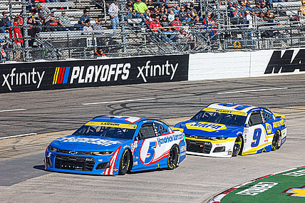 Oct 31, 2021; Martinsville, Virginia, USA; NASCAR Cup Series driver Kyle Larson (5) leads races Chase Elliott (9) at the 73rd Annual Xfinity 500 at Martinsville Speedway. Mandatory Credit: Ryan Hunt-USA TODAY Sports