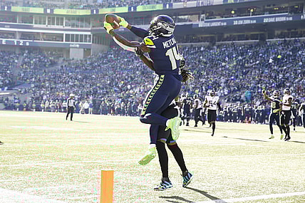 Oct 31, 2021; Seattle, Washington, USA; Seattle Seahawks wide receiver DK Metcalf (14) catches a touchdown pass against Jacksonville Jaguars cornerback Shaquill Griffin (26) during the second quarter at Lumen Field. Mandatory Credit: Joe Nicholson-USA TODAY Sports