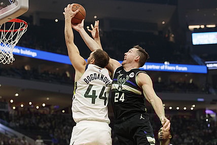 Oct 31, 2021; Milwaukee, Wisconsin, USA;  Utah Jazz forward Bojan Bogdanovic (44) and Milwaukee Bucks guard Pat Connaughton (24) reach for a rebound during the first quarter at Fiserv Forum. Mandatory Credit: Jeff Hanisch-USA TODAY Sports