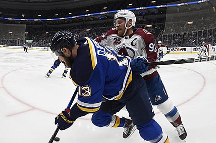 May 21, 2021; St. Louis, Missouri, USA; Colorado Avalanche left wing Gabriel Landeskog (92) checks St. Louis Blues left wing Kyle Clifford (13)in game three of the first round of the 2021 Stanley Cup Playoffs at Enterprise Center. Mandatory Credit: Jeff Le-USA TODAY Sports