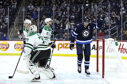 Nov 2, 2021; Winnipeg, Manitoba, CAN; Winnipeg Jets right wing Blake Wheeler (26) celebrates the second period goal by Winnipeg Jets defenseman Josh Morrissey (44) on Dallas Stars goaltender Braden Holtby (70) at Canada Life Centre. Mandatory Credit: James Carey Lauder-USA TODAY Sports