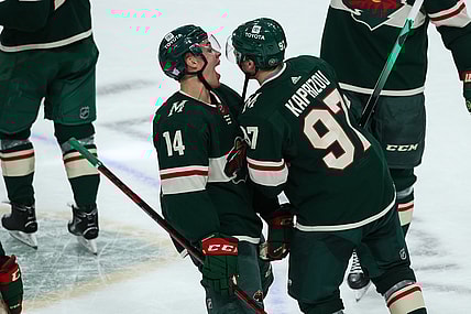 Nov 2, 2021; Saint Paul, Minnesota, USA; Minnesota Wild center Joel Eriksson Ek (14) celebrates with left wing Kirill Kaprizov (97) after Kaprizov scored a goal against the Ottawa Senators in overtime at Xcel Energy Center. Mandatory Credit: David Berding-USA TODAY Sports