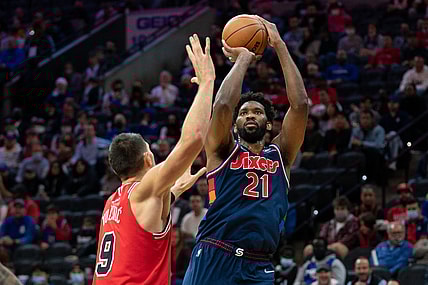 Nov 3, 2021; Philadelphia, Pennsylvania, USA; Philadelphia 76ers center Joel Embiid (21) shoots past Chicago Bulls center Nikola Vucevic (9) during the first quarter at Wells Fargo Center. Mandatory Credit: Bill Streicher-USA TODAY Sports