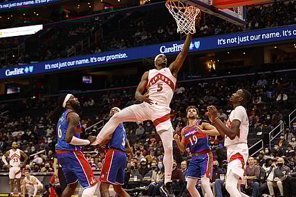 Nov 3, 2021; Washington, District of Columbia, USA; Toronto Raptors forward Precious Achiuwa (5) shoots the ball as Washington Wizards center Montrezl Harrell (6) looks on during the first quarter at Capital One Arena. Mandatory Credit: Geoff Burke-USA TODAY Sports