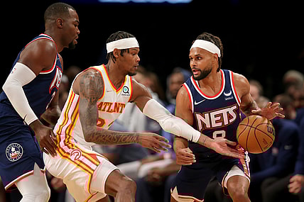 Nov 3, 2021; Brooklyn, New York, USA; Atlanta Hawks forward Cam Reddish (22) reaches for a ball controlled by Brooklyn Nets guard Patty Mills (8) in front of Nets forward Paul Millsap (31) during the second quarter at Barclays Center. Mandatory Credit: Brad Penner-USA TODAY Sports