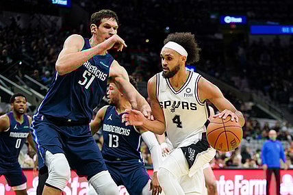 Nov 3, 2021; San Antonio, Texas, USA;  San Antonio Spurs guard Derrick White (4) dribbles against Dallas Mavericks center Boban Marjanovic (51) in the first half at the AT&T Center. Mandatory Credit: Daniel Dunn-USA TODAY Sports