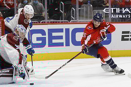 Oct 19, 2021; Washington, District of Columbia, USA; Washington Capitals center Nic Dowd (26) shoots the puck on Colorado Avalanche goaltender Darcy Kuemper (35) at Capital One Arena. Mandatory Credit: Geoff Burke-USA TODAY Sports