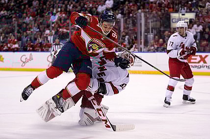 Nov 6, 2021; Sunrise, Florida, USA; Florida Panthers left wing Ryan Lomberg (94) collides with Carolina Hurricanes goaltender Antti Raanta (32) during the second period at FLA Live Arena. Mandatory Credit: Jasen Vinlove-USA TODAY Sports