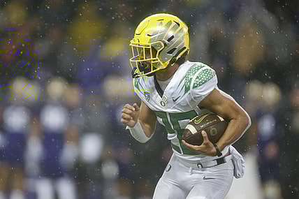 Nov 6, 2021; Seattle, Washington, USA; Oregon Ducks running back Travis Dye (26) rushes against the Washington Huskies during the second quarter at Alaska Airlines Field at Husky Stadium. Mandatory Credit: Joe Nicholson-USA TODAY Sports