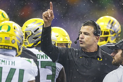 Nov 6, 2021; Seattle, Washington, USA; Oregon Ducks head coach Mario Cristobal speaks with his players during a second quarter timeout against the Washington Huskies at Alaska Airlines Field at Husky Stadium. Mandatory Credit: Joe Nicholson-USA TODAY Sports
