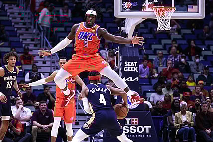 Nov 10, 2021; New Orleans, Louisiana, USA;  Oklahoma City Thunder forward Luguentz Dort (5) tries to block. Shot by New Orleans Pelicans guard Devonte' Graham (4) during the first half at Smoothie King Center. Mandatory Credit: Stephen Lew-USA TODAY Sports
