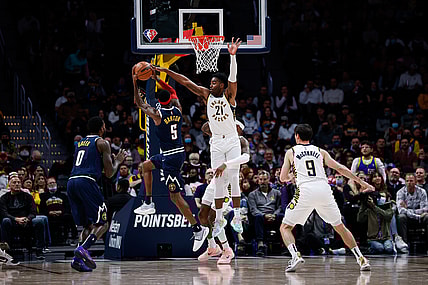 Nov 10, 2021; Denver, Colorado, USA; Denver Nuggets forward Will Barton (5) attempts a shot against Indiana Pacers guard Kelan Martin (21) and forward Torrey Craig (13) as forward JaMychal Green (0) and guard T.J. McConnell (9) defend in the second quarter at Ball Arena. Mandatory Credit: Isaiah J. Downing-USA TODAY Sports