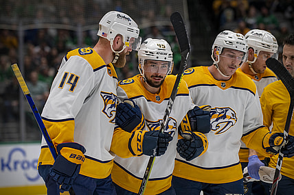 Nov 10, 2021; Dallas, Texas, USA; Nashville Predators defenseman Alexandre Carrier (45) is helped off the ice by defenseman Mattias Ekholm (14) and center Mikael Granlund (64) during the second period against the Dallas Stars at the American Airlines Center. Mandatory Credit: Jerome Miron-USA TODAY Sports