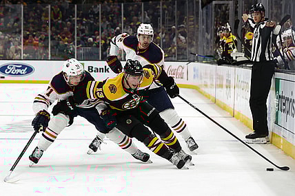 Nov 11, 2021; Boston, Massachusetts, USA; Boston Bruins center Charlie Coyle (13) tries to go around Edmonton Oilers center Ryan McLeod (71) during the first period at TD Garden. Mandatory Credit: Winslow Townson-USA TODAY Sports