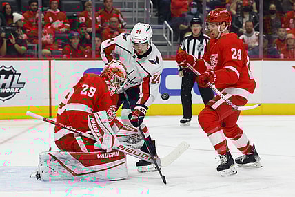 Nov 11, 2021; Detroit, Michigan, USA;  Detroit Red Wings goaltender Thomas Greiss (29) makes a save in front of Washington Capitals center Connor McMichael (24) and center Pius Suter (24) in the first period at Little Caesars Arena. Mandatory Credit: Rick Osentoski-USA TODAY Sports