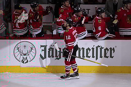 Nov 12, 2021; Chicago, Illinois, USA; Chicago Blackhawks left wing Alex DeBrincat (12) celebrates his goal against the Arizona Coyotes during the second period at United Center. Mandatory Credit: David Banks-USA TODAY Sports