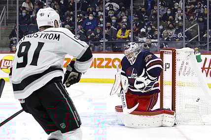 Nov 13, 2021; Winnipeg, Manitoba, CAN; Los Angeles Kings left wing Carl Grundstrom (91) scores a goal on Winnipeg Jets goaltender Connor Hellebuyck (37) in the first period at Canada Life Centre. Mandatory Credit: James Carey Lauder-USA TODAY Sports