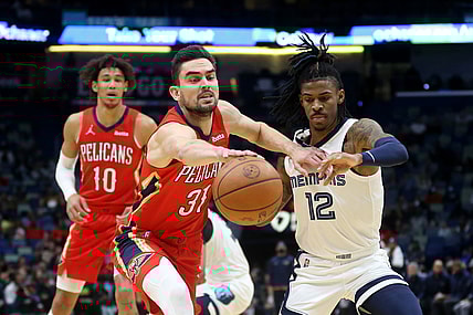 Nov 13, 2021; New Orleans, Louisiana, USA; New Orleans Pelicans guard Tomas Satoransky (31) and Memphis Grizzlies guard Ja Morant (12) battle for the ball in the first quarter at the Smoothie King Center. Mandatory Credit: Chuck Cook-USA TODAY Sports