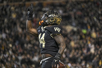 Nov 13, 2021; Winston-Salem, North Carolina, USA; Wake Forest Demon Deacons running back Justice Ellison (14) celebrates after scoring a touchdown against the North Carolina State Wolfpack during the first half at Truist Field. Mandatory Credit: William Howard-USA TODAY Sports