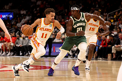 Nov 14, 2021; Atlanta, Georgia, USA; Atlanta Hawks guard Trae Young (11) drives against Milwaukee Bucks guard Jrue Holiday (21) during the second quarter at State Farm Arena. Mandatory Credit: Jason Getz-USA TODAY Sports