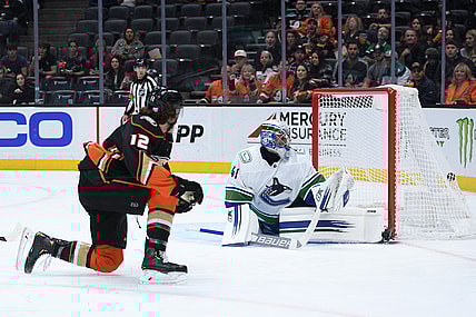 Nov 14, 2021; Anaheim, California, USA; Anaheim Ducks left wing Sonny Milano (12) scores a goal past Vancouver Canucks goaltender Jaroslav Halak (41) during the second period at Honda Center. Mandatory Credit: Orlando Ramirez-USA TODAY Sports