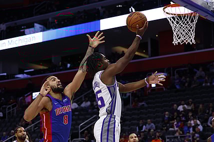 Nov 15, 2021; Detroit, Michigan, USA;  Sacramento Kings guard Davion Mitchell (15) goes to the basket on Detroit Pistons forward Trey Lyles (8) in the first half at Little Caesars Arena. Mandatory Credit: Rick Osentoski-USA TODAY Sports
