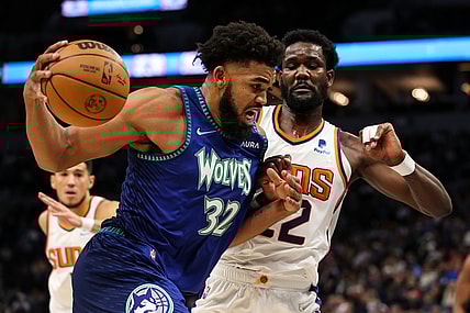 Nov 15, 2021; Minneapolis, Minnesota, USA; Minnesota Timberwolves center Karl-Anthony Towns (32) drives to the basket while Phoenix Suns center Deandre Ayton (22) defends in the first half at Target Center. Mandatory Credit: David Berding-USA TODAY Sports