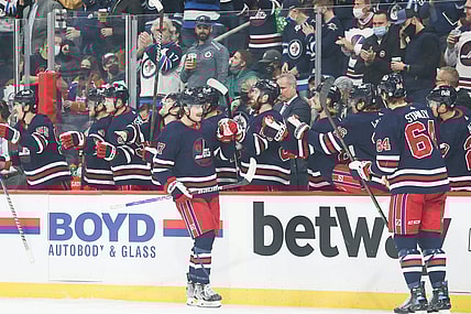 Nov 16, 2021; Winnipeg, Manitoba, CAN;  Winnipeg Jets forward Adam Lowry (17) is congratulated by his team mates on his goal against the Edmonton Oilers during the first period at Canada Life Centre. Mandatory Credit: Terrence Lee-USA TODAY Sports