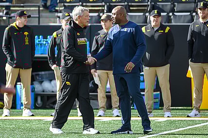 Nov 20, 2021; Iowa City, Iowa, USA;  Iowa Hawkeyes head coach Kirk Ferentz and Illinois Fighting Illini acting head coach George McDonald meet before the game at Kinnick Stadium. Mandatory Credit: Steven Branscombe-USA TODAY Sports