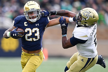 Nov 20, 2021; South Bend, Indiana, USA; Notre Dame Fighting Irish running back Kyren Williams (23) stiff arms Georgia Tech Yellow Jackets safey Tariq Carpenter (2) in the second quarter at Notre Dame Stadium. Mandatory Credit: Matt Cashore-USA TODAY Sports