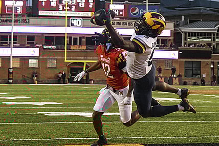 Nov 20, 2021; College Park, Maryland, USA; Michigan Wolverines wide receiver Mike Sainristil (5) catches a one handed touchdown as Maryland Terrapins defensive back Tarheeb Still (12) defends during the first half at Capital One Field at Maryland Stadium. Mandatory Credit: Tommy Gilligan-USA TODAY Sports